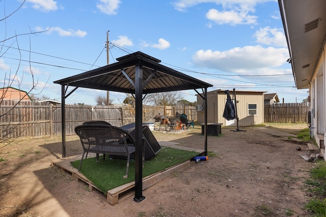 view of yard with a gazebo and a storage unit