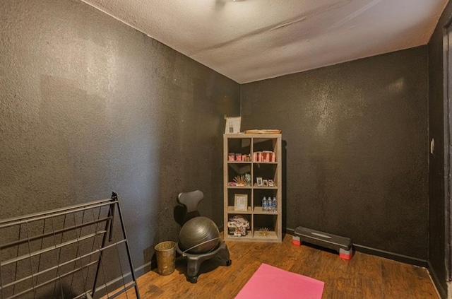 exercise room with dark wood-type flooring