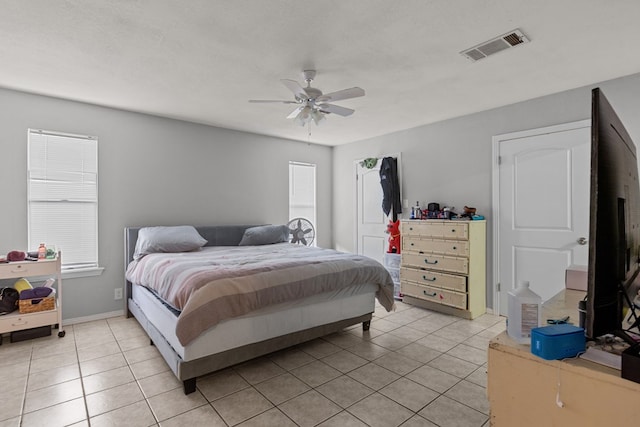 bedroom with ceiling fan and light tile patterned flooring