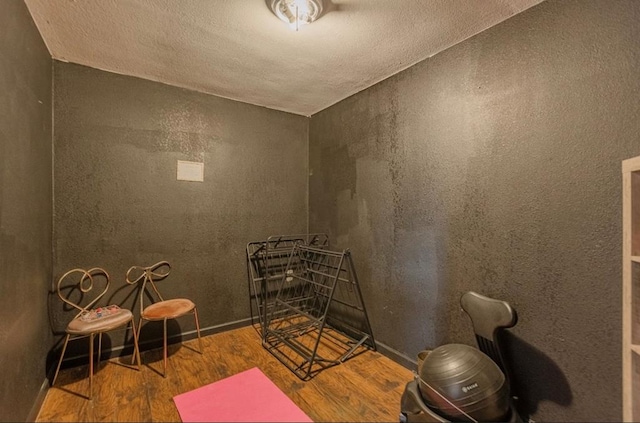 exercise room with wood-type flooring