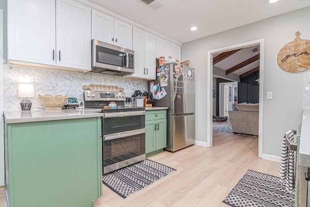 kitchen with tasteful backsplash, green cabinets, appliances with stainless steel finishes, and visible vents
