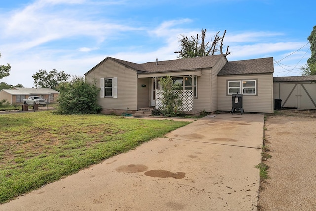 2004 N Monticello St, Big Spring, TX 79720 - view of front of home featuring a front yard, concrete driveway, and roof with shingles
