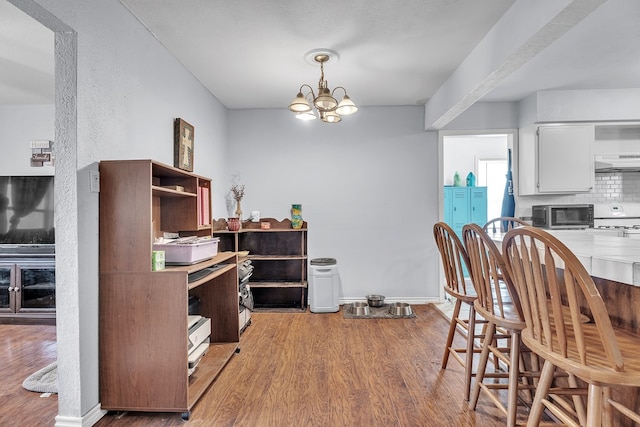 2004 N Monticello St, Big Spring, TX 79720 - dining area with light wood-style floors and a chandelier