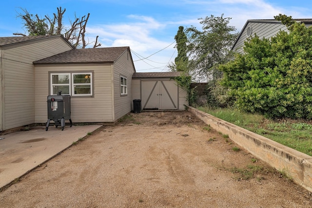 2004 N Monticello St, Big Spring, TX 79720 - view of property exterior featuring a shingled roof and a shed