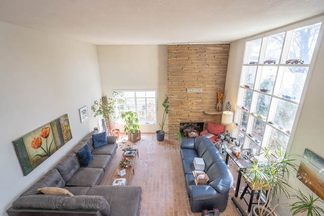 living room featuring wood finished floors and a stone fireplace