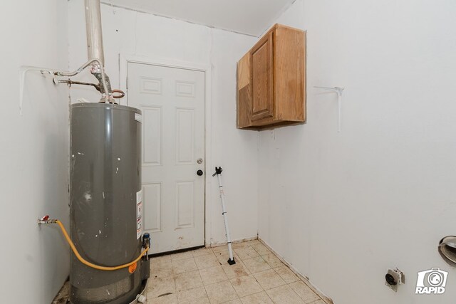 laundry area featuring cabinets and gas water heater