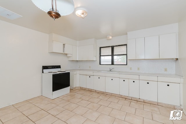 kitchen featuring white cabinets, white electric stove, hanging light fixtures, and sink