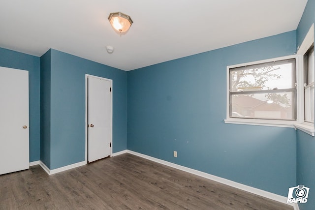 unfurnished bedroom featuring dark wood-type flooring