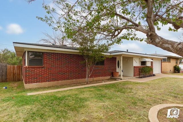 ranch-style home featuring a front lawn and a garage