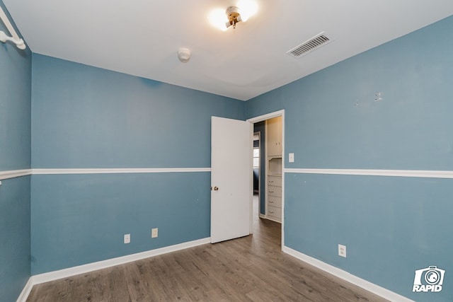 empty room with wood-type flooring