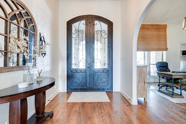801 Keystone Ct, Midland, TX 79705 - foyer entrance with arched walkways, wood finished floors, french doors, and baseboards