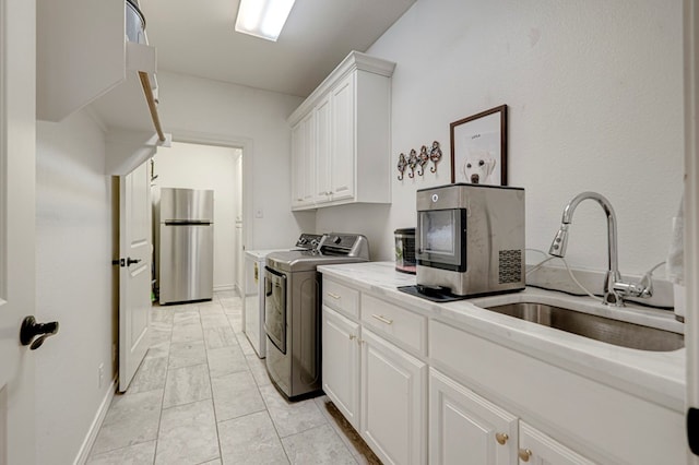 801 Keystone Ct, Midland, TX 79705 - laundry area with washing machine and dryer, light marble finish floors, cabinet space, and baseboards