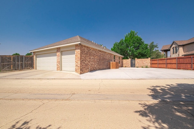 801 Keystone Ct, Midland, TX 79705 - view of property exterior featuring brick siding, driveway, and an attached garage