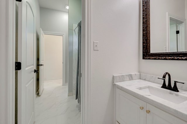 801 Keystone Ct, Midland, TX 79705 - bathroom with marble look tile flooring and vanity