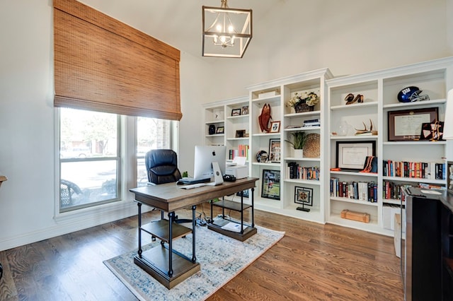 801 Keystone Ct, Midland, TX 79705 - office space featuring a chandelier, a high ceiling, and dark wood-style flooring