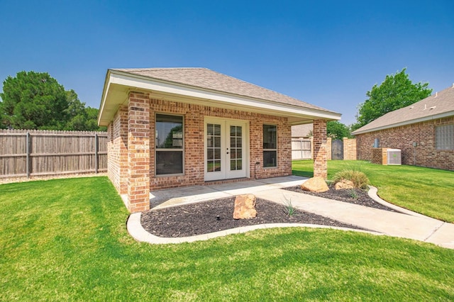 801 Keystone Ct, Midland, TX 79705 - back of house with french doors, brick siding, cooling unit, and roof with shingles