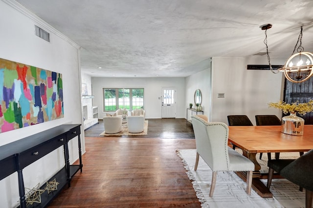 2202 Princeton Ave, Midland, TX 79701 - dining space featuring a chandelier, wood finished floors, and baseboards
