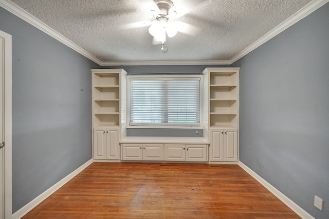 2202 Princeton Ave, Midland, TX 79701 - spare room with a textured ceiling, ceiling fan, wood finished floors, baseboards, and ornamental molding