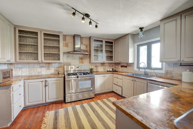 2202 Princeton Ave, Midland, TX 79701 - kitchen with wall chimney range hood, stainless steel appliances, a sink, and tasteful backsplash