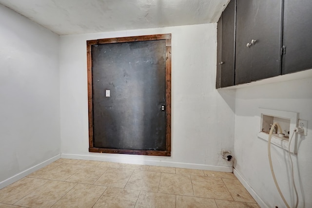 2202 Princeton Ave, Midland, TX 79701 - washroom with cabinet space, baseboards, washer hookup, and tile patterned flooring