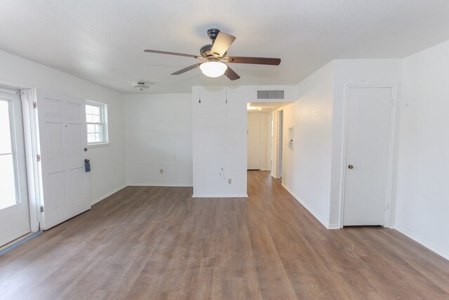 empty room with hardwood / wood-style floors and ceiling fan