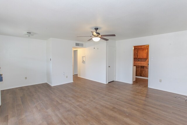 unfurnished room featuring dark hardwood / wood-style floors and ceiling fan