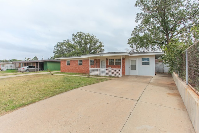 ranch-style home featuring a carport and a front lawn