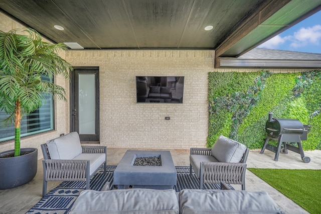 view of patio / terrace with an outdoor living space with a fire pit and area for grilling