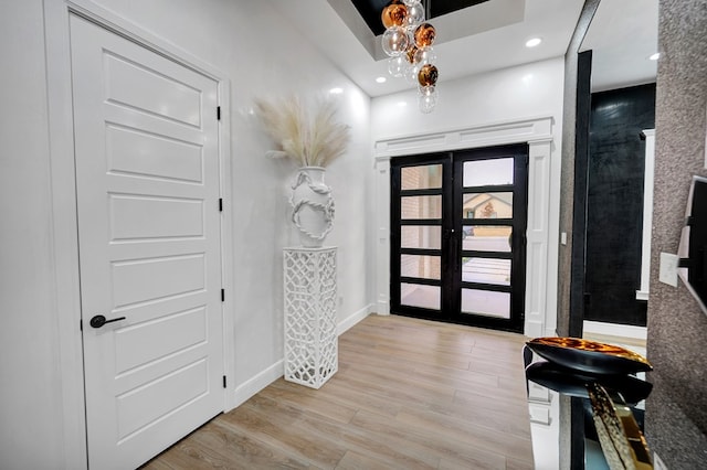 entryway featuring french doors, recessed lighting, light wood-type flooring, and baseboards