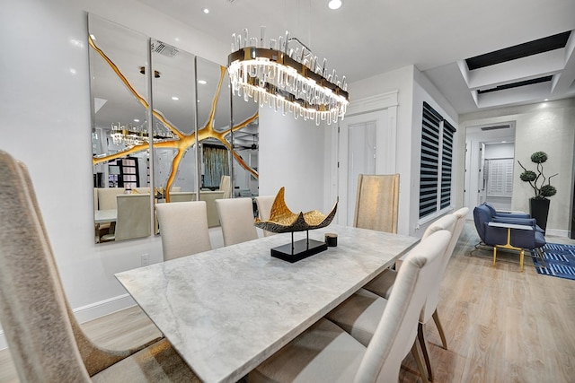 dining space featuring stairway, an inviting chandelier, wood finished floors, and baseboards