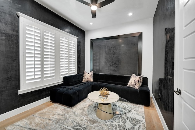 living area with recessed lighting, ceiling fan, baseboards, and wood finished floors