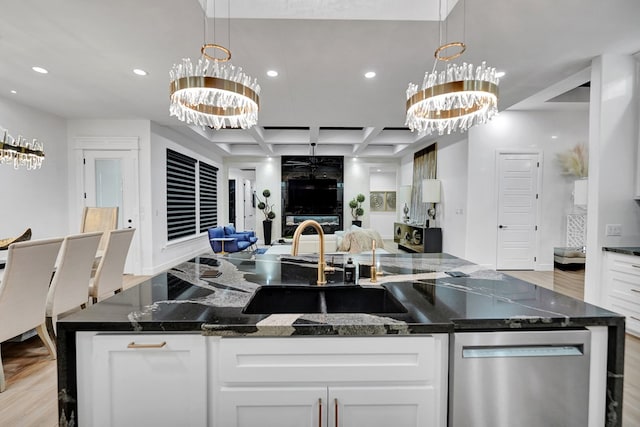 kitchen featuring coffered ceiling, dishwasher, open floor plan, light wood-type flooring, and a chandelier