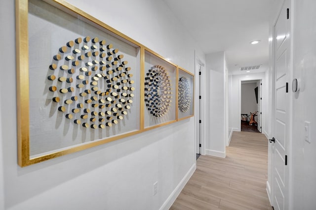 corridor featuring baseboards, visible vents, wood finished floors, and recessed lighting