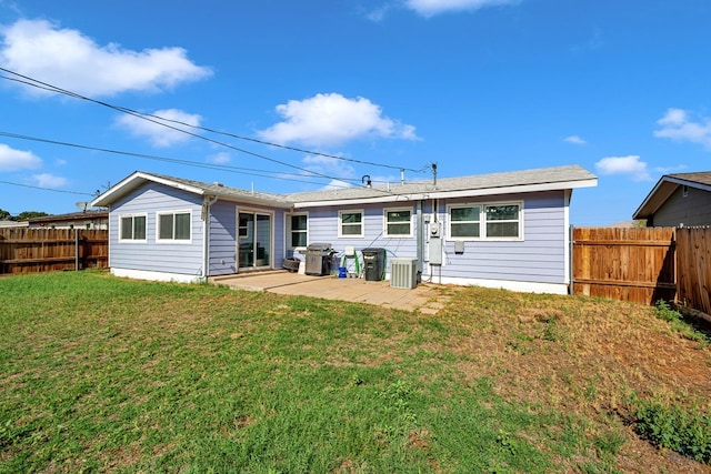 back of property featuring a fenced backyard, a lawn, a patio area, and cooling unit