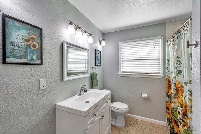 full bath with vanity, curtained shower, toilet, baseboards, and a textured ceiling