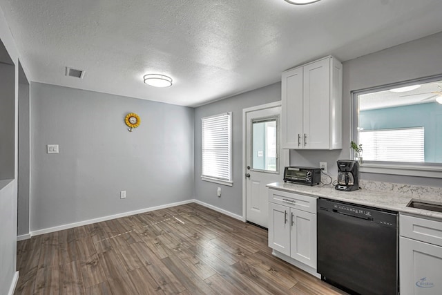 kitchen featuring visible vents, dark wood-type flooring, a textured ceiling, and dishwasher