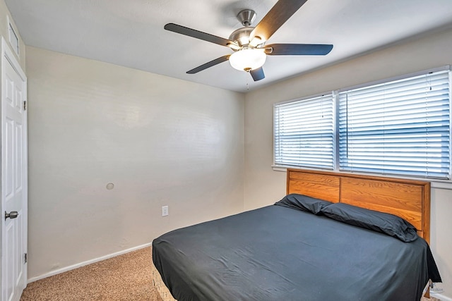 bedroom with carpet floors, baseboards, ceiling fan, and visible vents