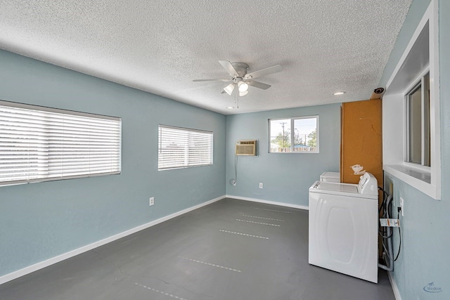 empty room featuring washer and dryer, a textured ceiling, a ceiling fan, a wall unit AC, and finished concrete floors