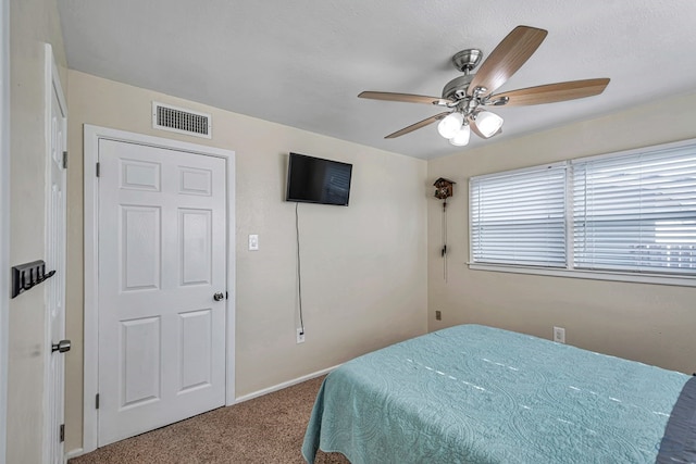 bedroom with carpet flooring, ceiling fan, visible vents, and baseboards