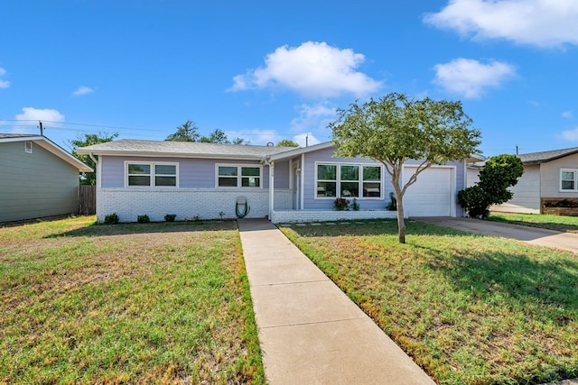 ranch-style home featuring brick siding, a garage, a front lawn, and driveway