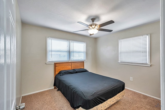 bedroom with baseboards, carpet flooring, and ceiling fan