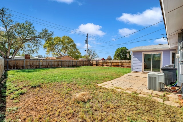 view of yard with a patio, central AC, and a fenced backyard