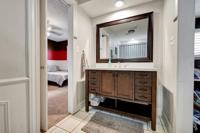 4107 Crestgate Ave, Midland, TX 79707 - bathroom with connected bathroom, a textured ceiling, vanity, and tile patterned floors