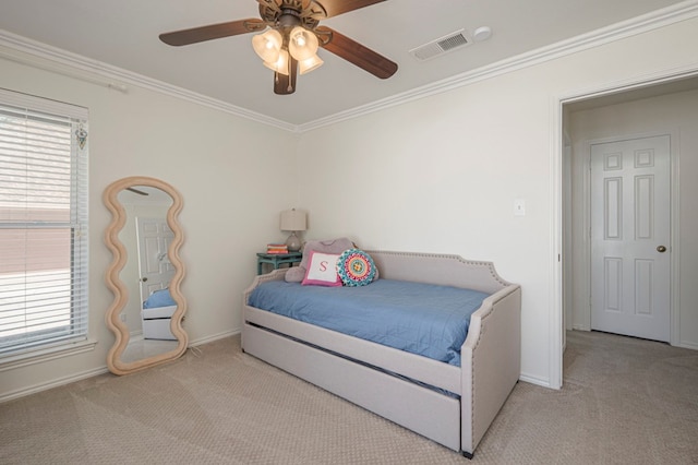 bedroom with carpet floors, visible vents, ornamental molding, and multiple windows