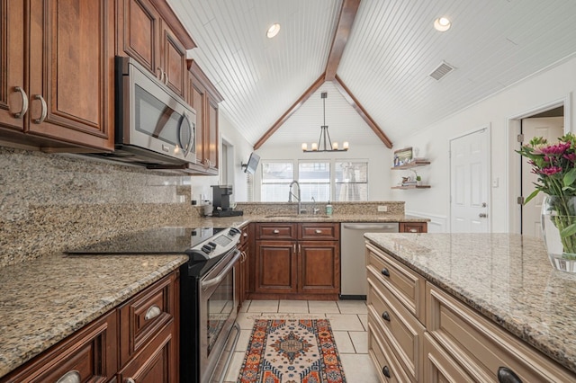 kitchen with light tile patterned floors, lofted ceiling with beams, a peninsula, stainless steel appliances, and a sink