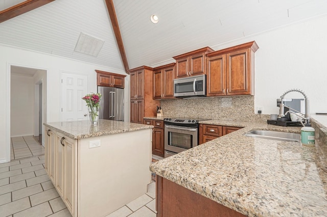 kitchen featuring light tile patterned floors, stainless steel appliances, decorative backsplash, a sink, and light stone countertops