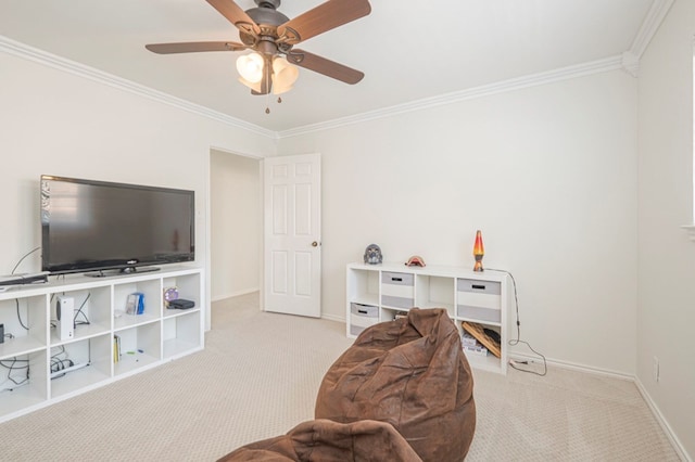 sitting room featuring a ceiling fan, carpet, ornamental molding, and baseboards