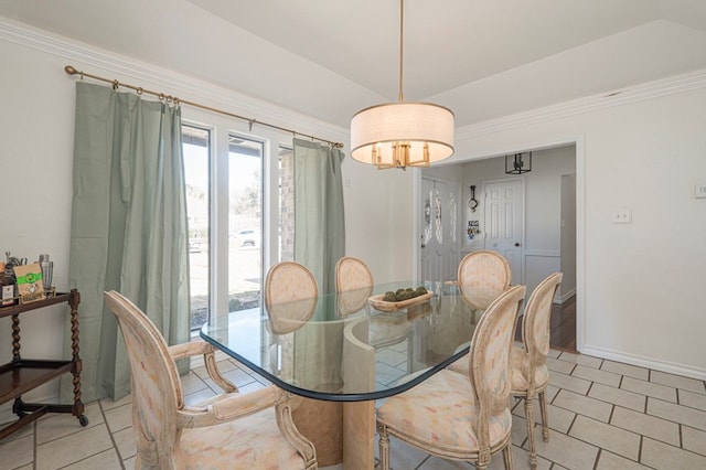 dining room with vaulted ceiling, light tile patterned floors, and baseboards