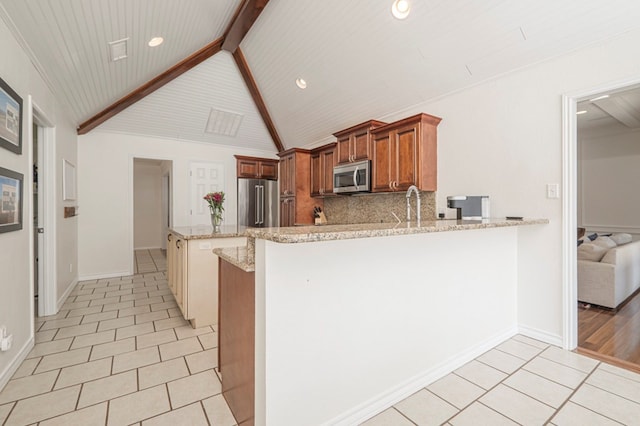 kitchen with light tile patterned floors, stainless steel appliances, a peninsula, decorative backsplash, and beamed ceiling