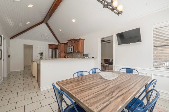 dining space with recessed lighting, ceiling fan, lofted ceiling with beams, and light tile patterned floors